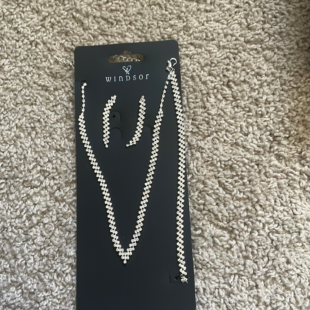 silver jewelry set, earrings, bracelet, & necklace. brand new never worn.